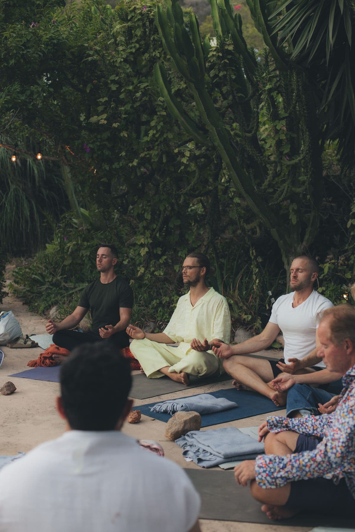 Group meditation in a tropical garden