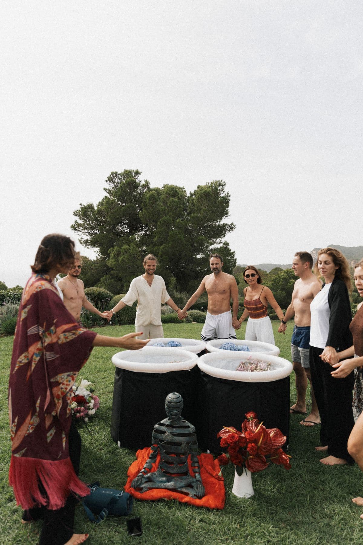 Group holding hands around cold plunges