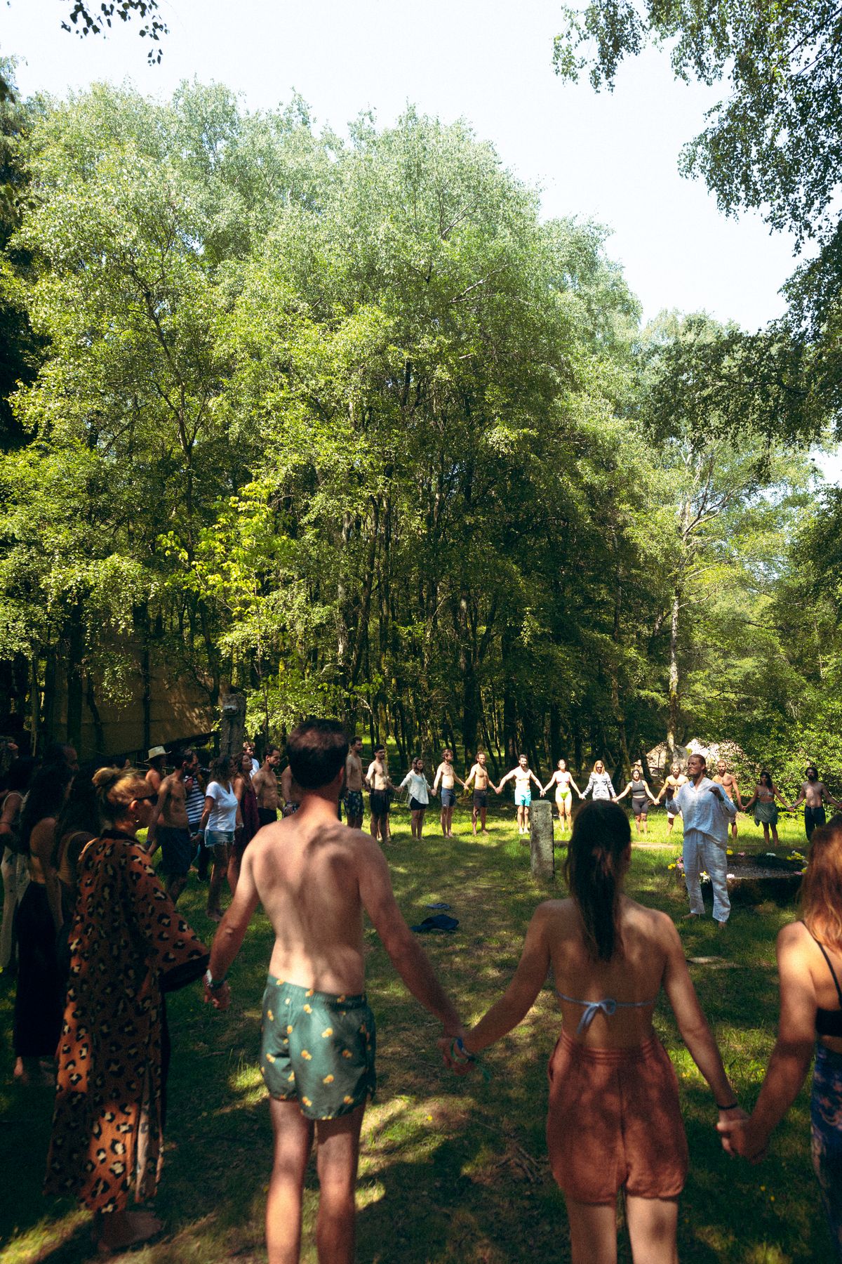 Huge group holding hands around an ice bath, Goat Community Festival 2023