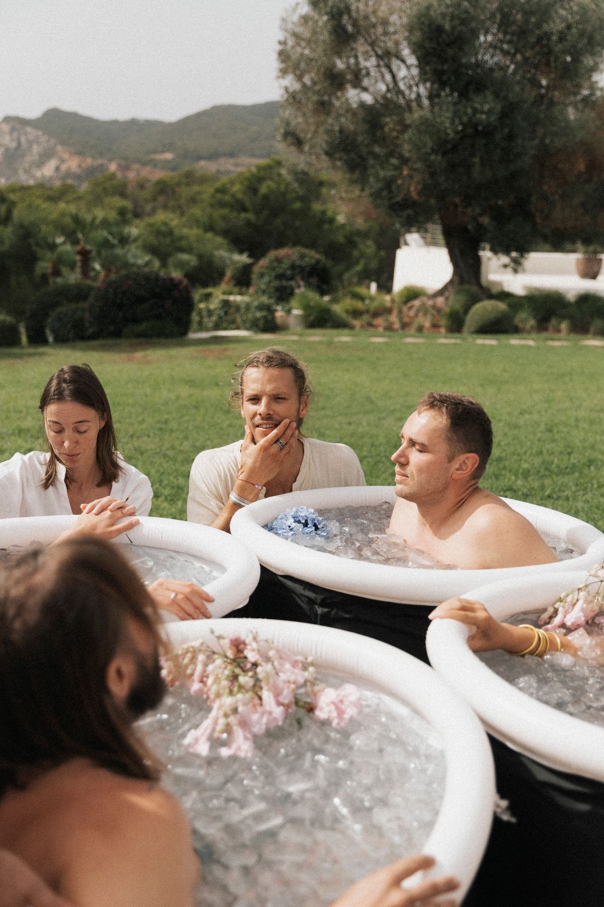 David guiding clients in cold plunges with flowers, Ibiza 2024