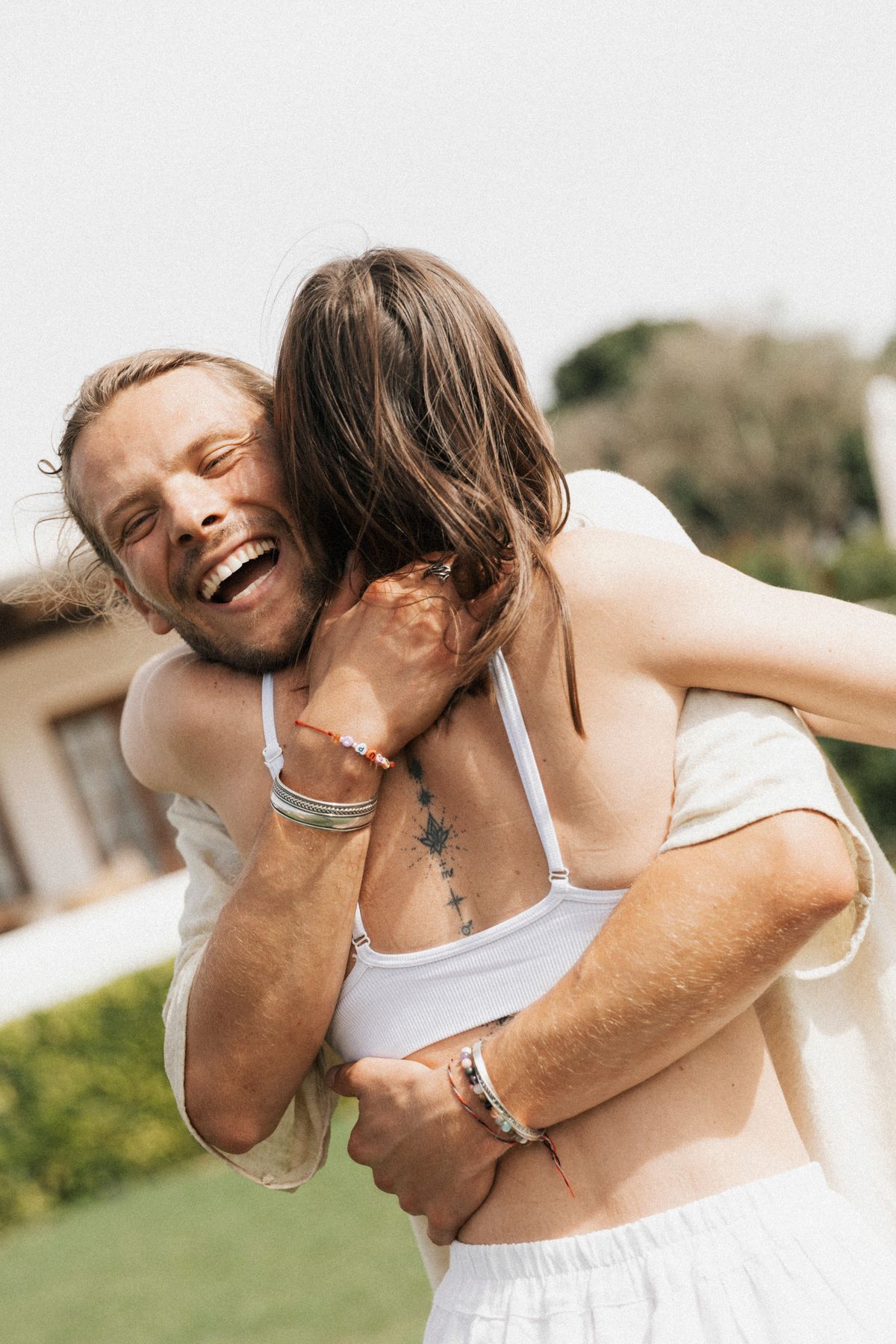 David hugging a client and laughing at Experiment Retreat Ibiza 2024